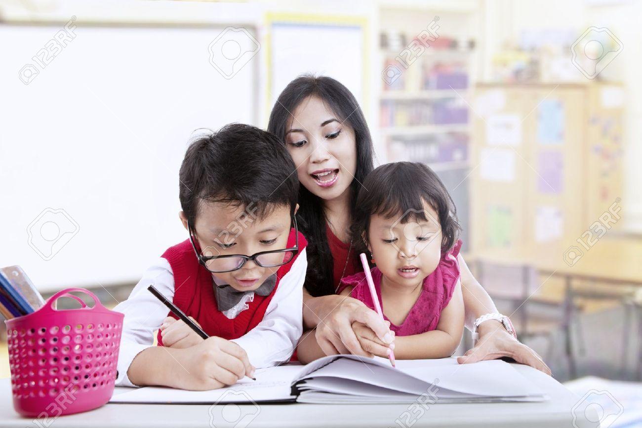 16823532 teacher and children study in classroom together stock photo asian